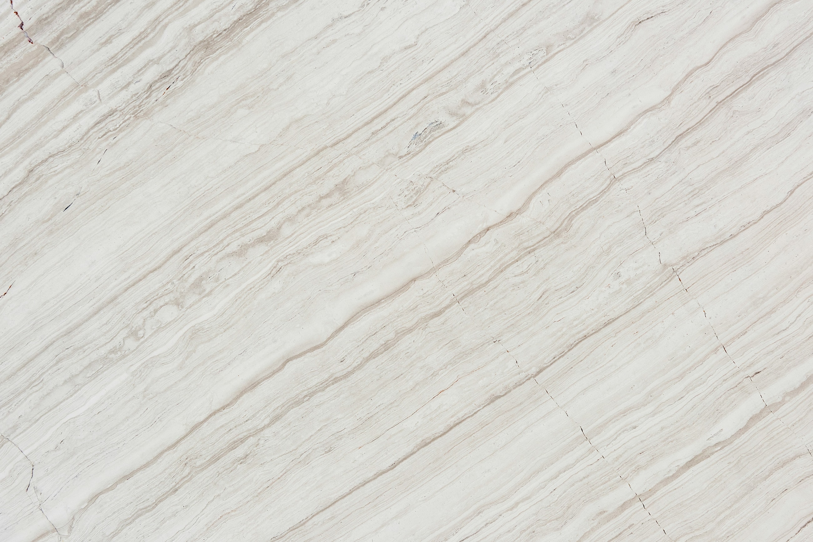 Textured white marble surface with subtle lines.