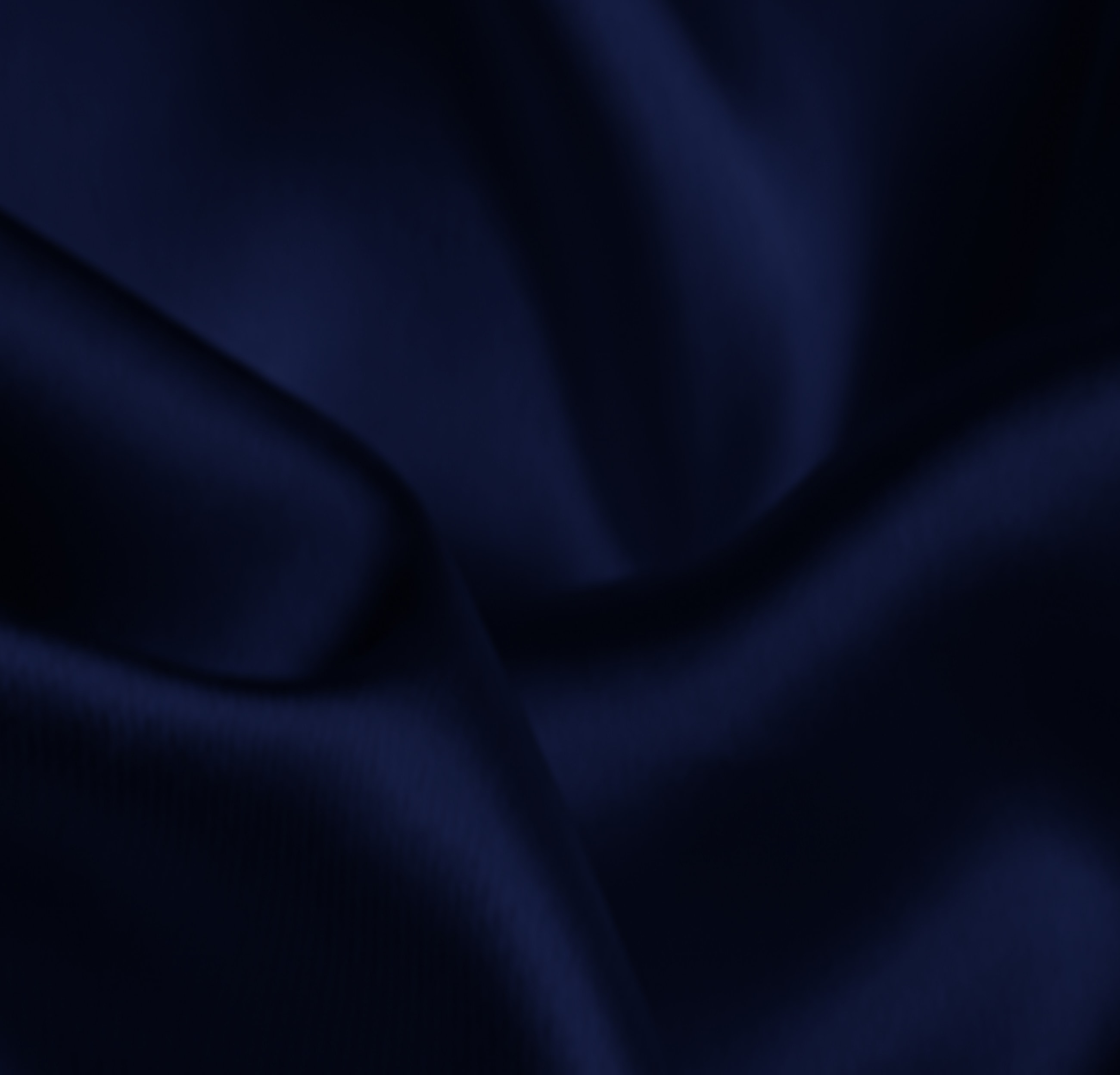 Rich dark blue satin fabric surface texture.