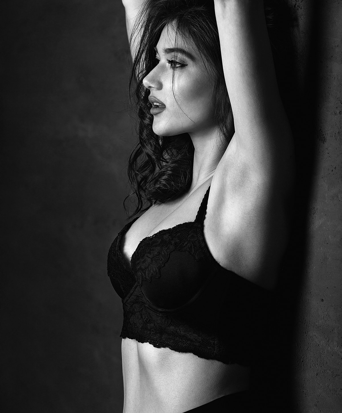 Person in black outfit sitting on chair.