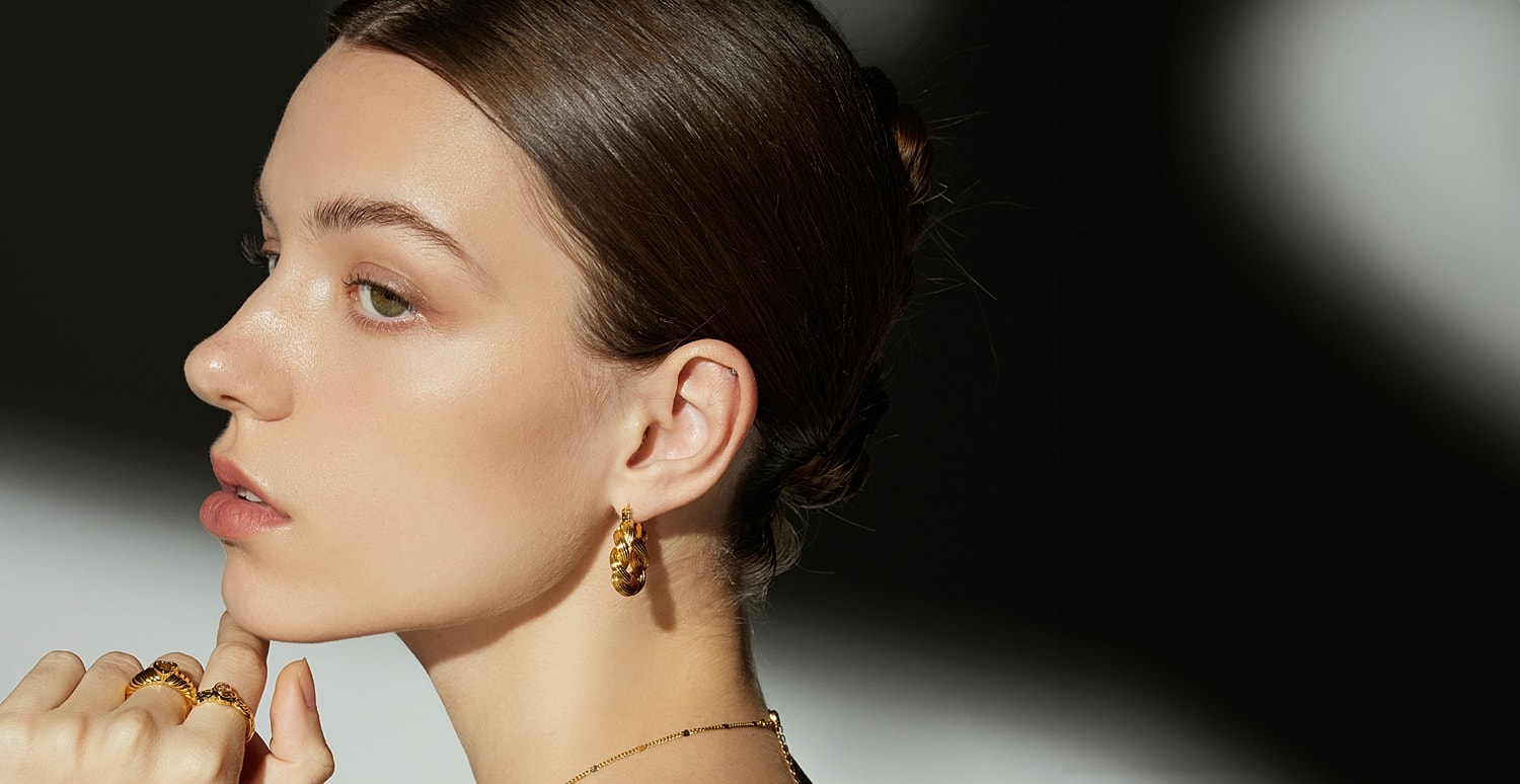 Model showcasing elegant jewelry and beauty.