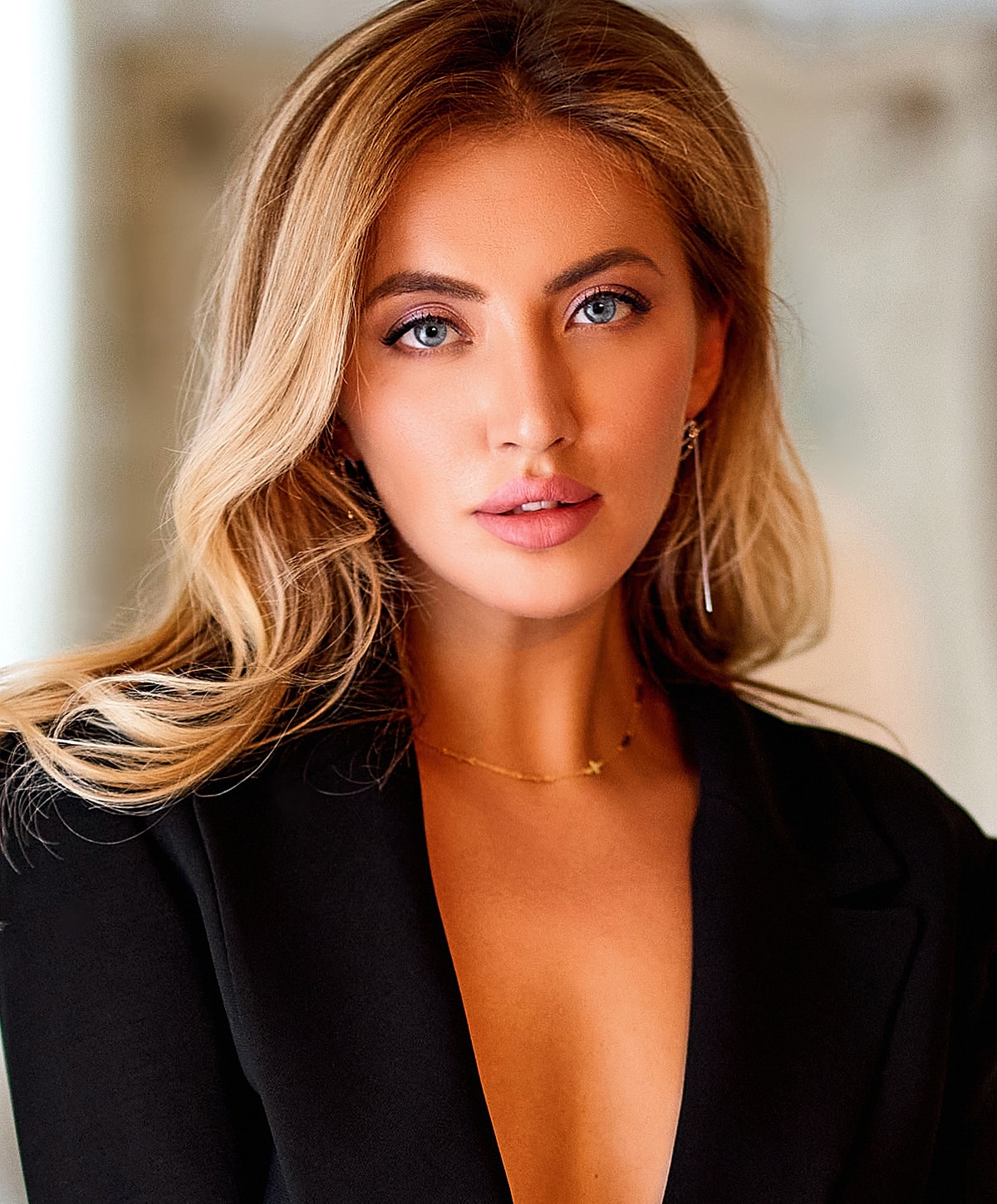 Portrait of a woman with wavy, blonde hair.