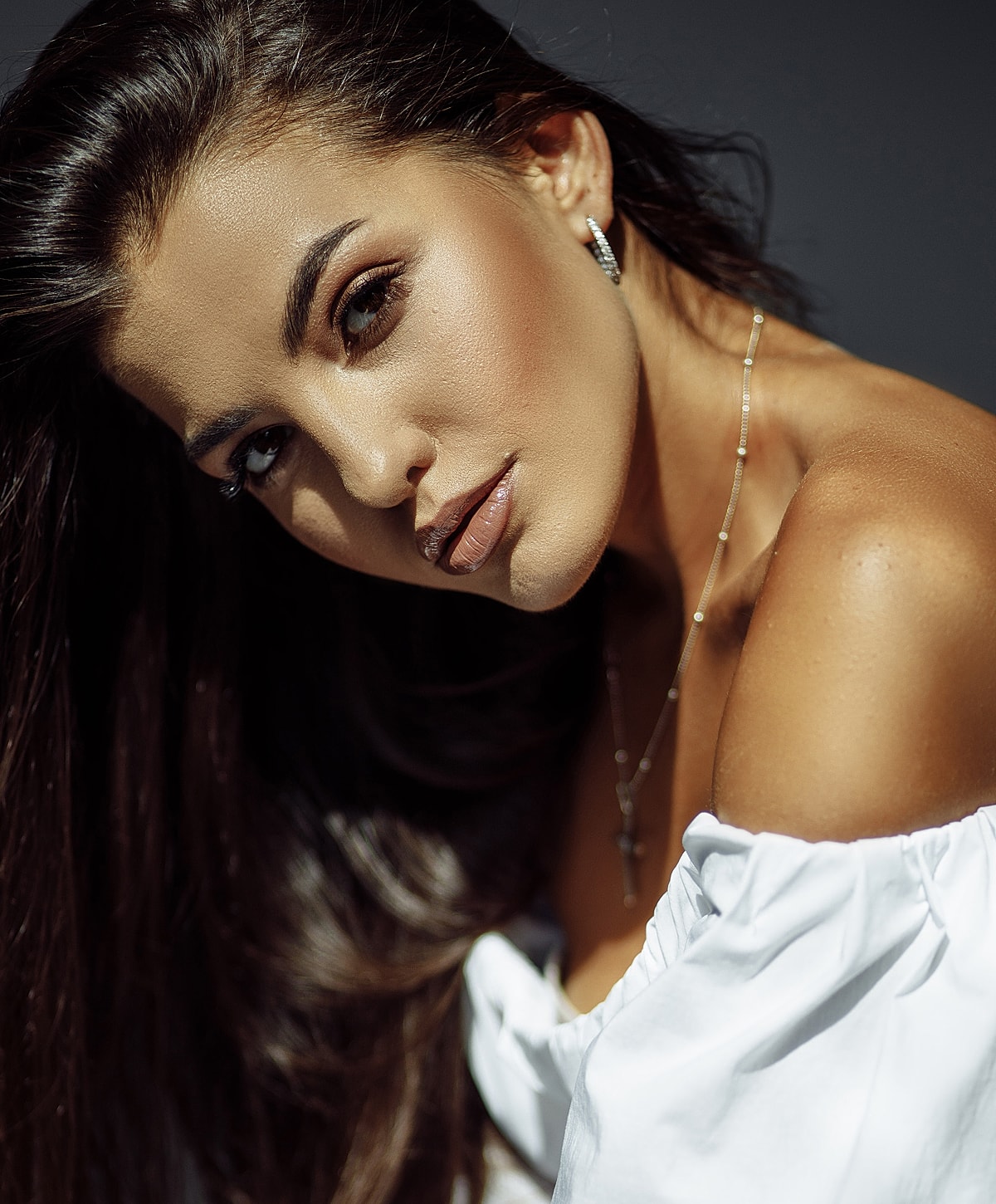 Woman with long hair in off-shoulder top.