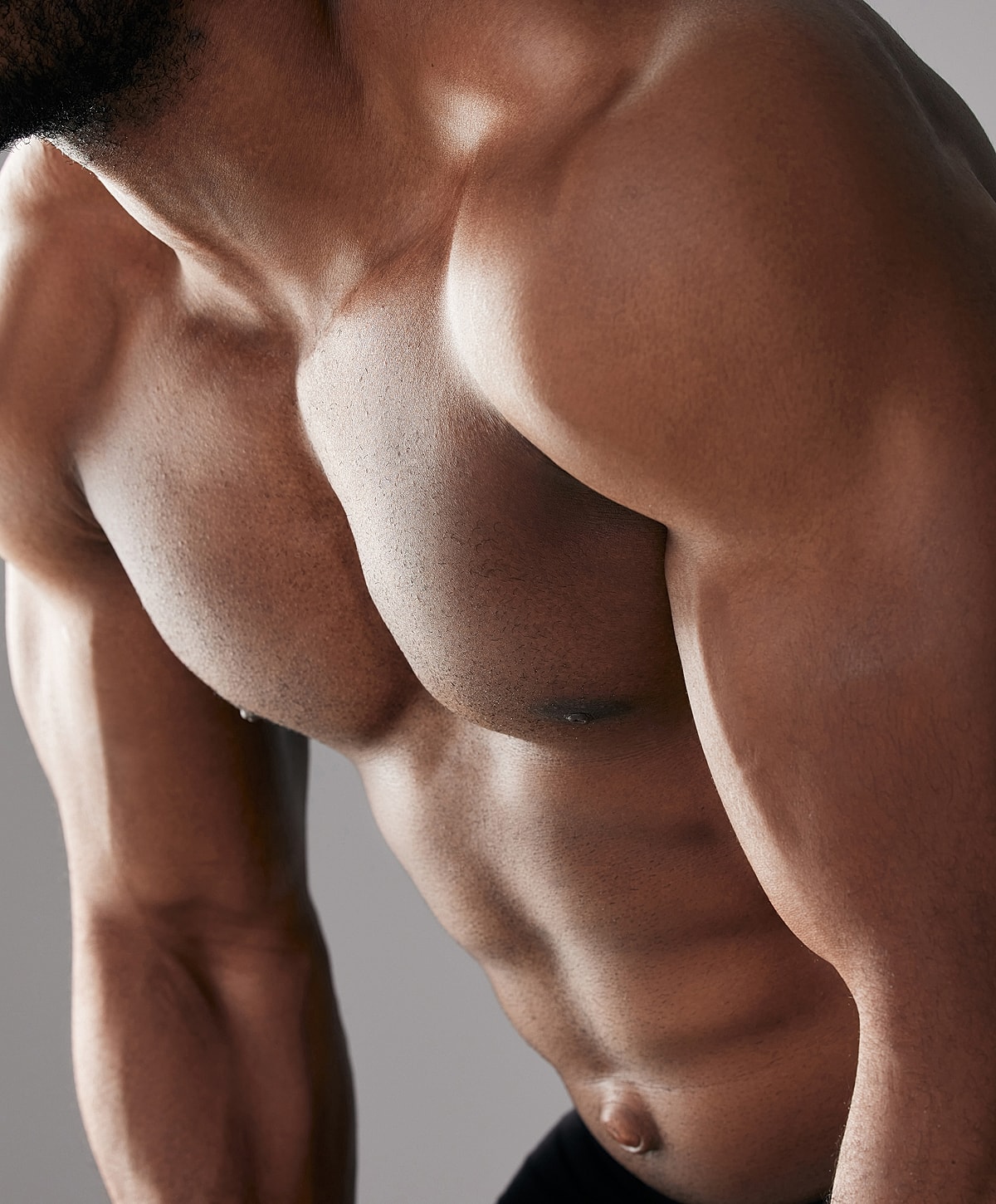 Close-up of muscular male torso and shoulders.