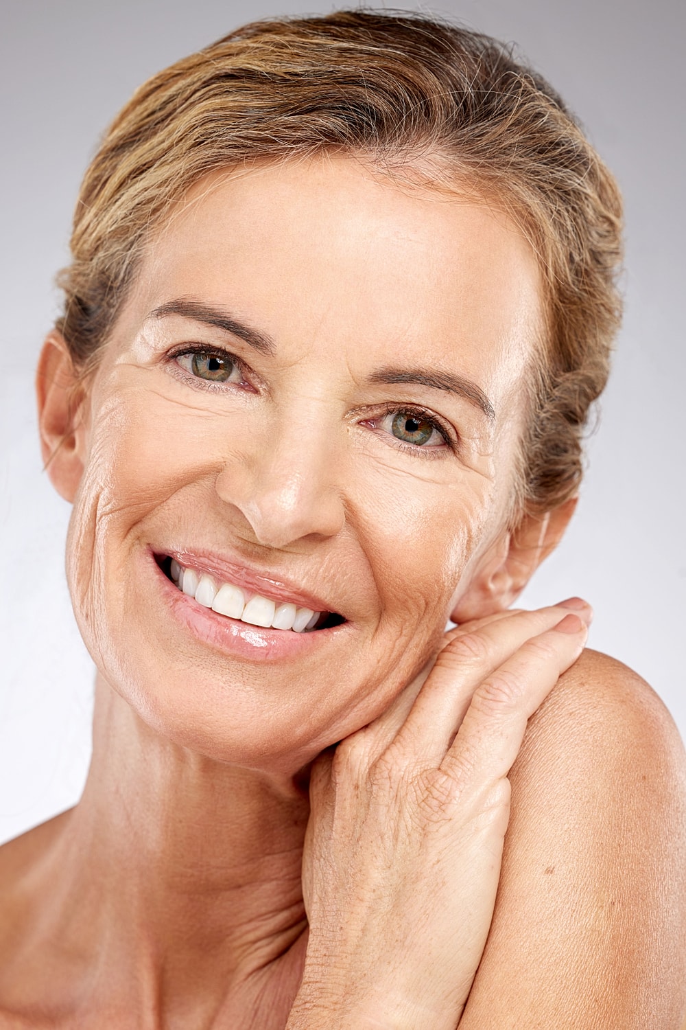 Smiling woman with healthy, glowing skin.