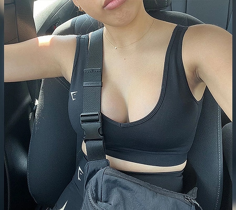 Person in car wearing black athletic clothing.