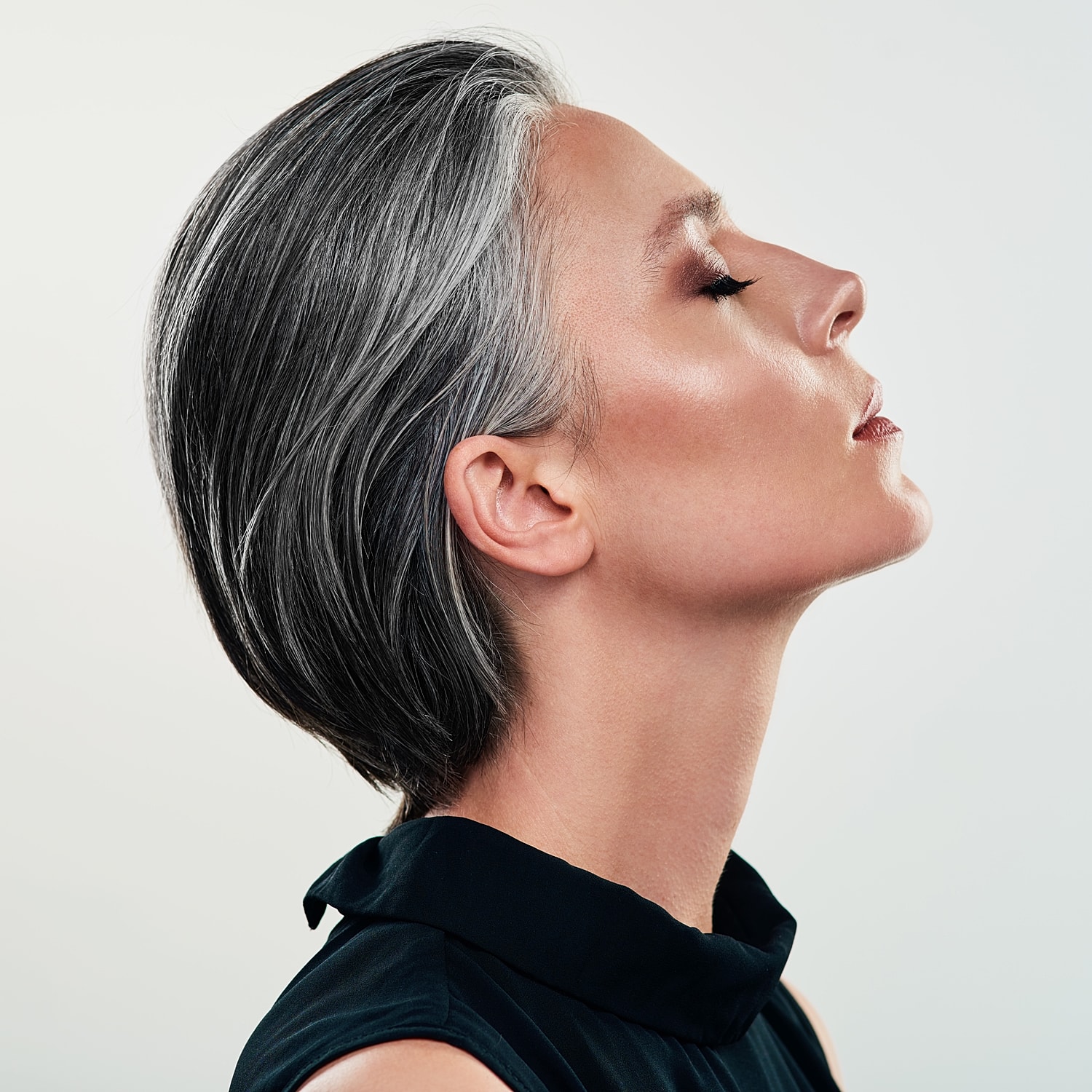 Profile of woman with short gray hair.