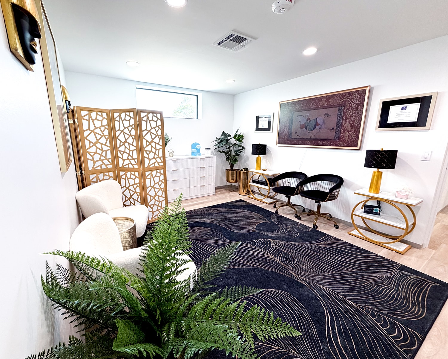 Modern office interior with decorative plants and artwork.