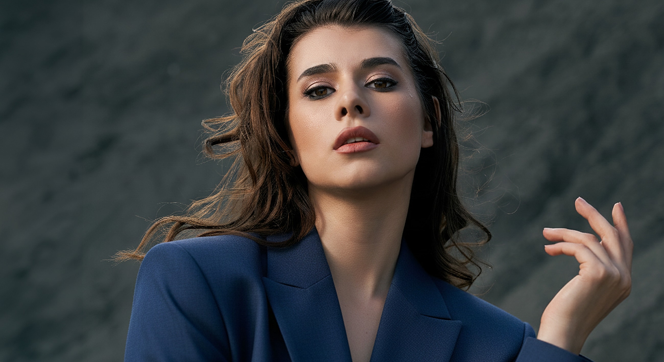 Model posing confidently in stylish blue blazer.